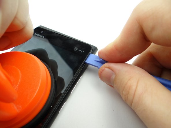 Picture 1: Slowly work your way to the top with the blue pry tool while continuing to pull up gently with the suction cup.