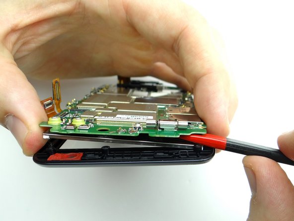 Picture 1: Insert spudger between the LCD and logic board where pictured.