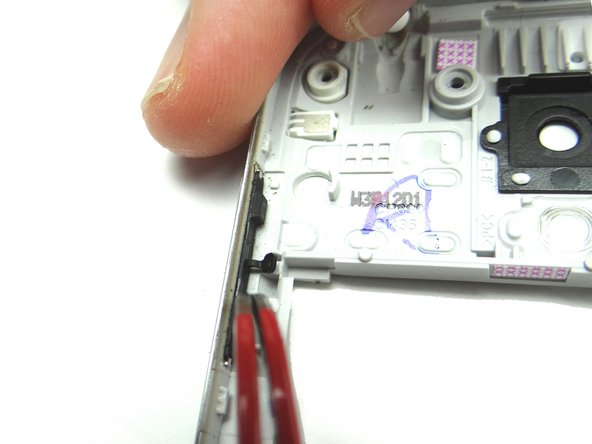 Picture 1: From COMPARTMENT B, push volume rocker into place with curved-tip tweezers.