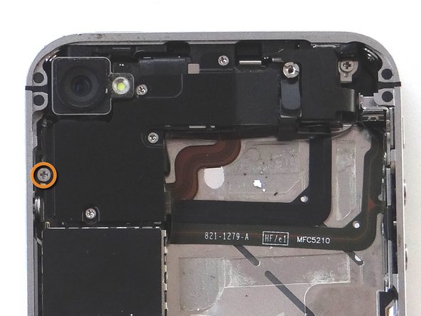 Remove five Phillips screws from the Cable Shield surrounding the camera.  Use fine point tweezers to remove them if the screwdriver won't hold them: