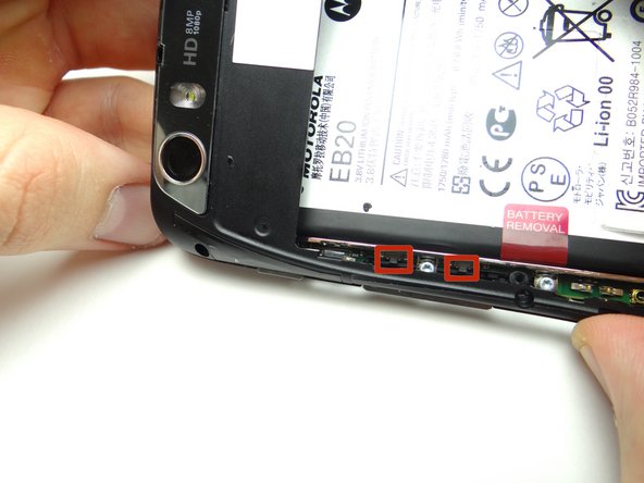 Picture 1: Be careful not to damage the volume rocker clips (red squares) while performing this step: