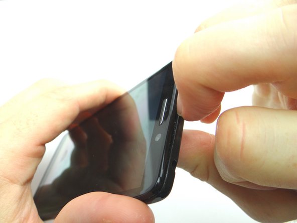 Picture 3: Snag the top of the battery cover with your fingernail and pull it slightly away from the front panel.