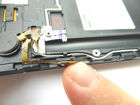 Place the power button ribbon cable down into position first.