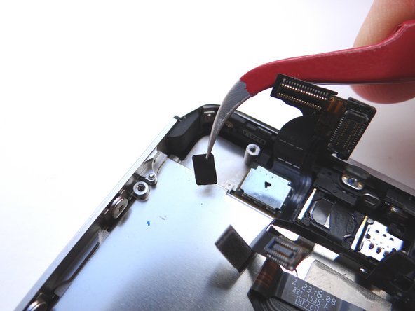 Picture 3: Remove the  1.5 mm Phillips screw behind the tape (upper left-hand corner) and place it in COMPARTMENT F.