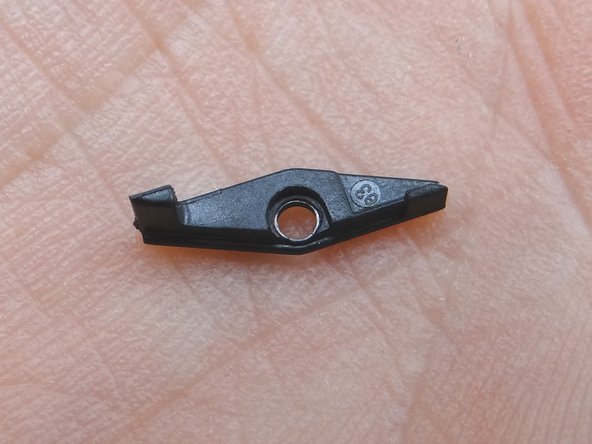 Remove SIM tray hinge and the 2.5 mm Phillips screw holding it down.  Place both in COMPARTMENT F.