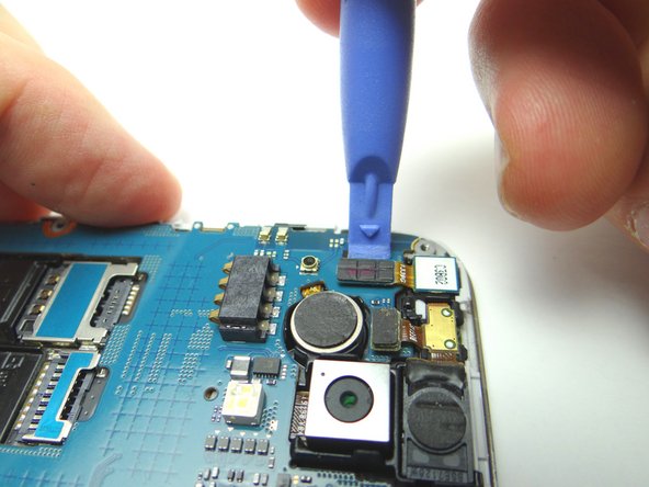 Use blue pry tool to disconnect front-facing camera cable.