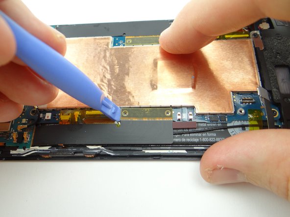 Pictures 2 &amp; 3: Use the blue pry tool to disconnect the two large daughter board flex cables from the main logic board.