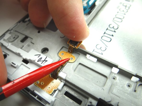 Line up the holes at the top and bottom of the contact pad with the tabs on the front panel.