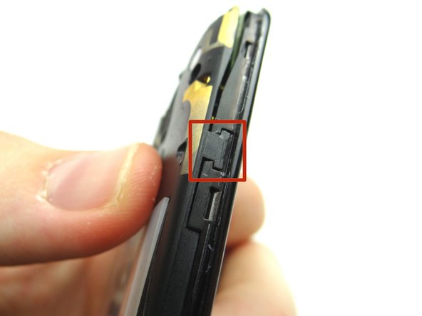 Use the guitar pick to free the marked clip while pulling the top edge of the panel with your finger