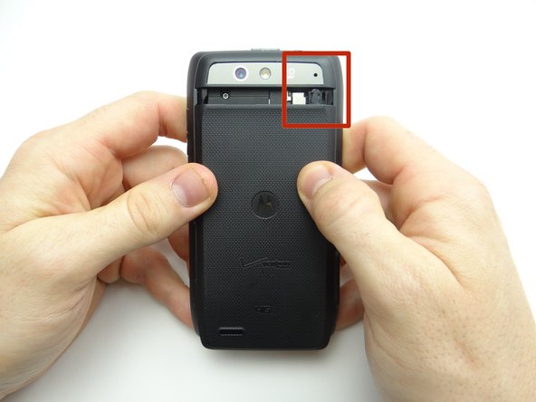 Picture 1: Retrieve the battery cover, then line it up as pictured.  Push the pressure tab under the opening in the rear camera cover while seating the battery cover.