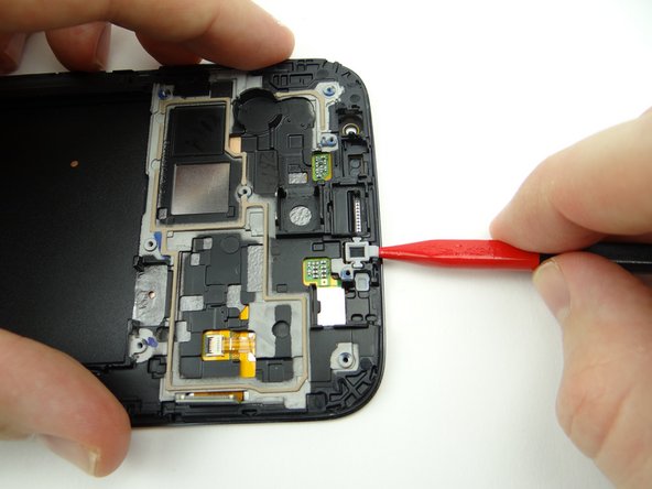 Use the spudger to lift the microphone cover up from the front panel.