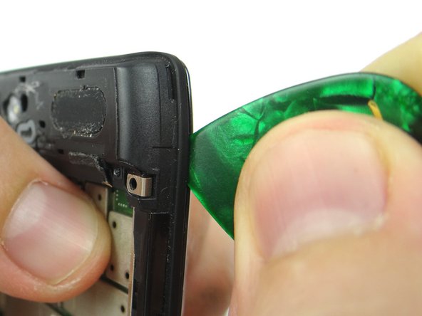 With the phone face down wedge the guitar pick between the display and mid-frame in the upper-right corner.  Run the guitar pick down the right side to release clips holding mid-frame to the display.