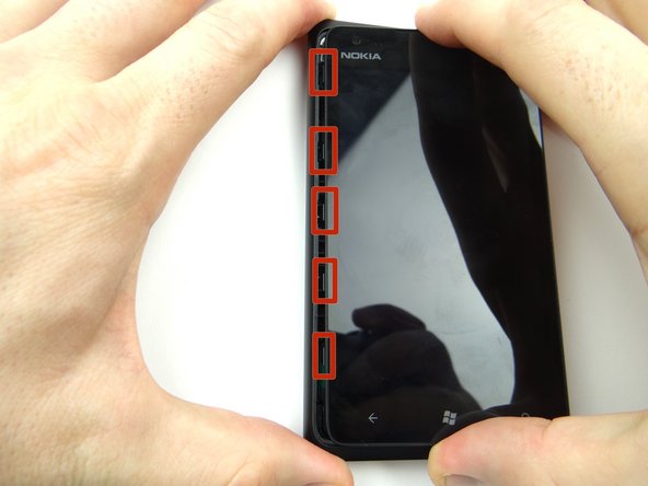 Don't try to open the phone just yet - the front panel is attached by two cables that tear easily.