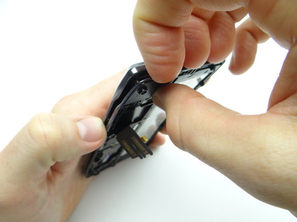 Separate the keyboard assembly from the front panel, starting in the upper-left corner.