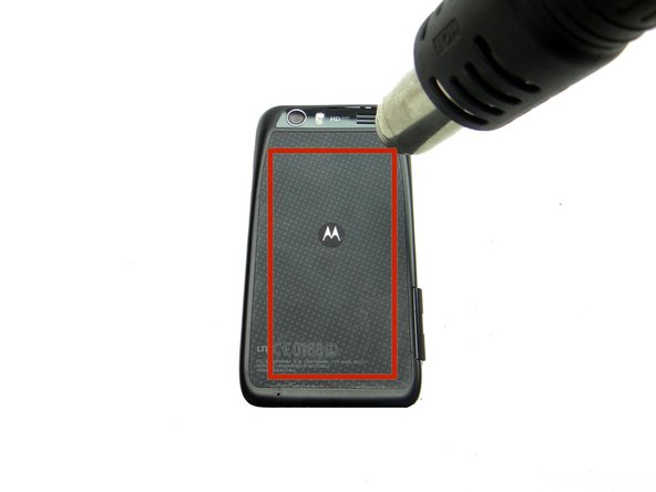 Adhesive holds the battery cover in place. Don't try to remove the battery cover just yet: