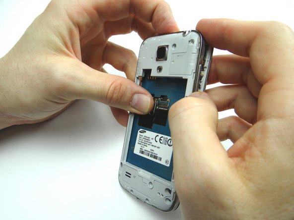 Continue peeling the mid-frame away from the front panel with your fingers.