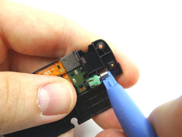 Picture 1: Use the blue pry tool to pry up the vibrator.