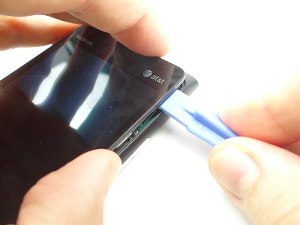 Work your way to the bottom of the display, freeing the clips from the rear panel.