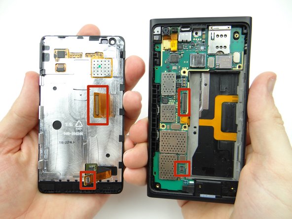 Place the display assembly over the rear panel at a roughly 70° angle so there's no tension on the display cables as you seat them on the logic board.