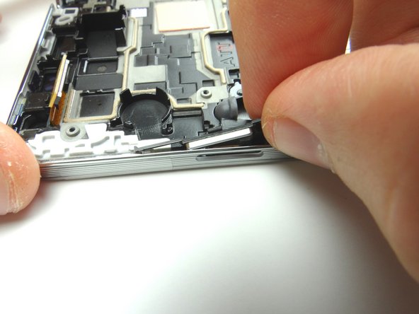 Use curved tip tweezers to press the button firmly into place.