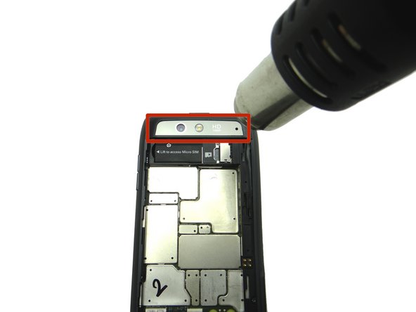 Picture 1: Heat the rear camera trim for 30 seconds to loosen the mild adhesive holding it in place.