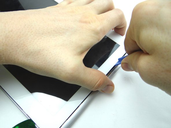 Pictures 1 &amp; 2: Continue lifting the upper-right corner until you can wedge the flat end of a spudger in the upper-right corner to hold it open.