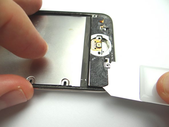 Picture 1 &amp; 2: Use the iSesamo to pry up the metal plate from bottom edge of the rear case.