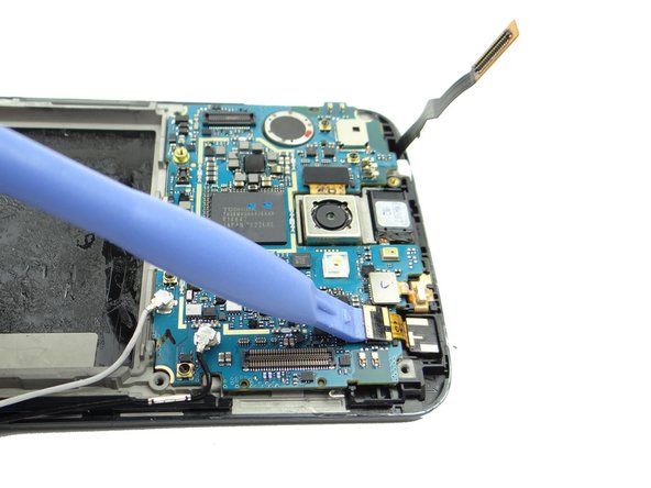 Use the blue pry tool to disconnect the front-facing camera.