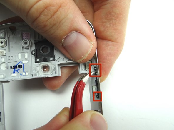 From COMPARTMENT C, seat power button.  Attach to the top and bottom tabs in the red squares.