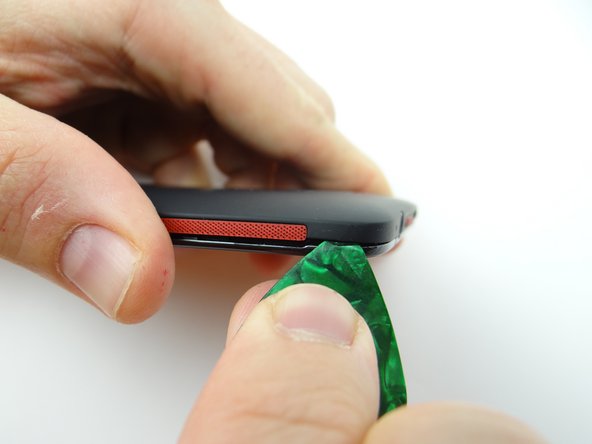 Pry up the corner near the headphone jack.