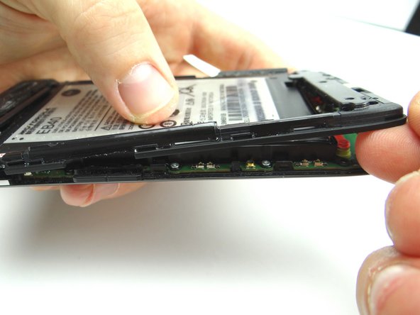 Use your fingers to continue peeling the remaining clips holding the mid-frame to the display.