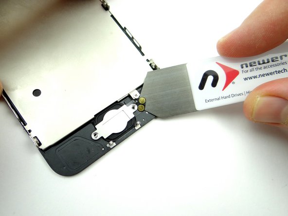 Picture 2: Wedge the iSesamo under the home button contacts.  With the right edge up, simply lift the home button bracket away from the phone with your fingers.