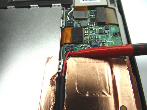 Picture 1: Wedge the pointed end of the spudger under lower speaker cable connector and lift straight up.