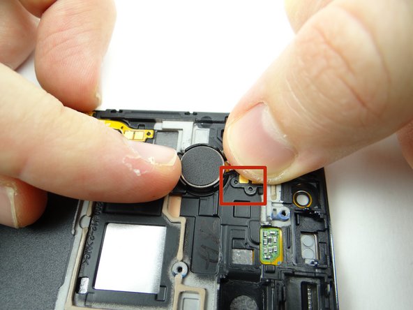 Line up openings on cable with tabs on front panel, then push vibrator cable and vibrator firmly into place.