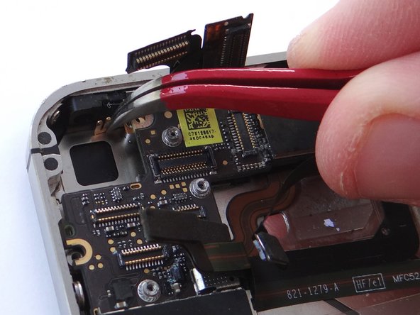 Remove 2.5 mm Phillips screw securing Gold Grounding Clip to logic board near rear camera opening.  Place screw in SLOT 6.