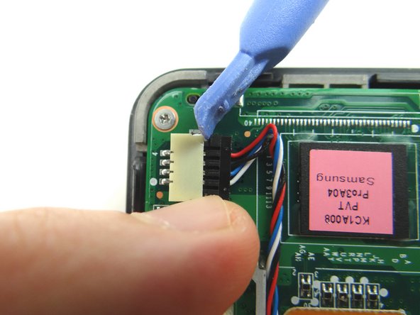 Picture 2: Wedge your fingers in the notches between the black speaker cable head and the white speaker connector.  Pull the black speaker cable head free.