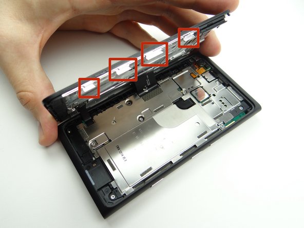 In the next few steps you'll be releasing clips holding the display assembly to the rear panel:
