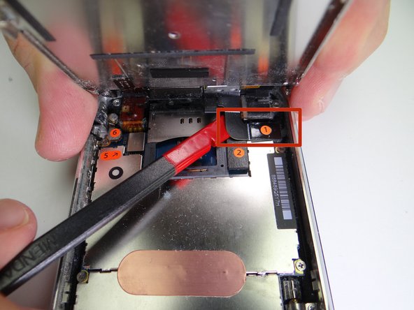Picture 3: While holding the front panel at a 45° angle, wedge spudger under cable '1' and rotate counter-clockwise until cable head is free.