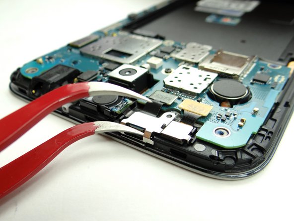 Picture 3: Wedge one prong of the curved-tip tweezers under the shield as shown.