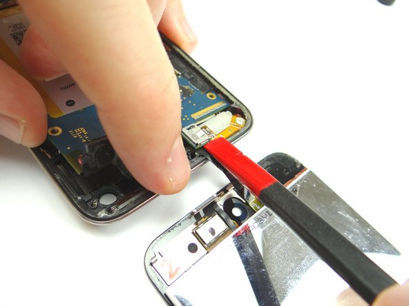 Picture 1: Use the Black Spudger to disconnect the digitizer ribbon underneath the logic board.  Separate the display assembly from the rear case.