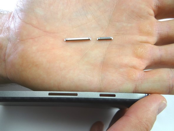 Picture 3: The power and volume buttons are now loose.  Place them in COMPARTMENT E.