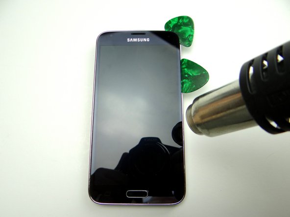 Picture 1: Insert a second guitar pick into the upper-right corner.  Apply heat down the right side.