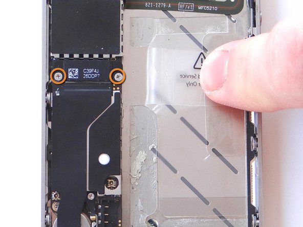 Remove two 1.8 mm Phillips screws from the charging port assembly shield.  Put screws in SLOT 8 as you remove them.