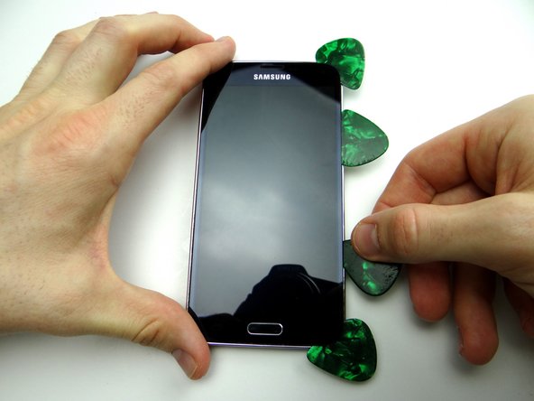 Picture 3: Work the third guitar pick until reaching the lower-right corner.  Leave it there and insert a fourth pick just above it.