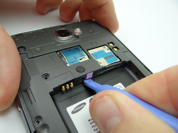 Pictures 1 &amp; 2: Use the Blue Pry Tool to free the clips on the bottom and top of the battery holding area.