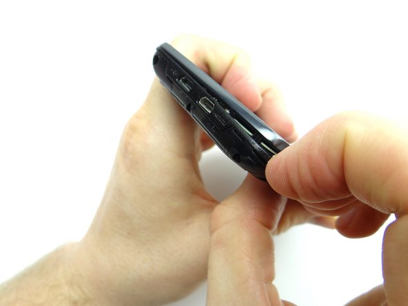 Picture 2:  Begin separating the mid-frame from the front panel in the upper-left hand corner (opposite the headphone jack).