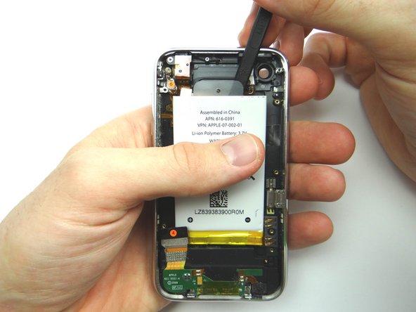 Picture 2: Use the spudger to push through the adhesive under the battery.