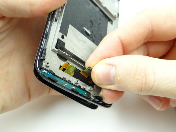 Use your fingers to continue separating the display from the mid-frame.