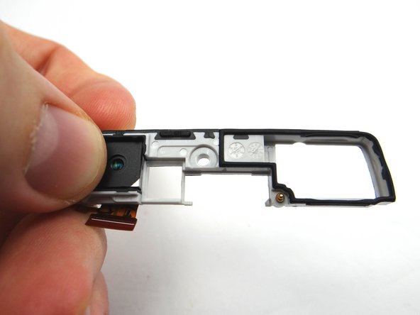Simply push the camera out through the underside of the antenna bracket.  Place antenna bracket in COMPARTMENT E.