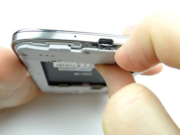 Pull the loudspeaker assembly away from the phone starting near the charging port.